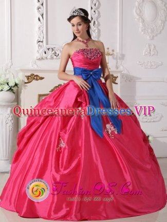 Formentera Spain Ball Gown Coral Red Sash Appliques and Beaded Decorate Bust Sweet 16 Dresses With a blue bow.