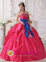 Caerphilly Mid Glamorgan Ball Gown Coral Red Sash Appliques and Beaded Decorate Bust Sweet 16 Dresses With a blue bow.